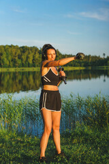 Beautiful woman exercising near the lake