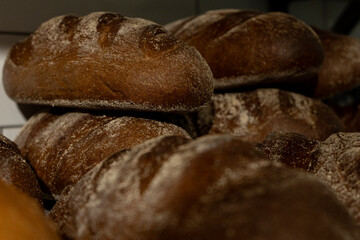Freshly baked rye oval bread on a bakery shelf. Close-up. sourdough bread. Loaves of bread on a store shelf. High quality photo