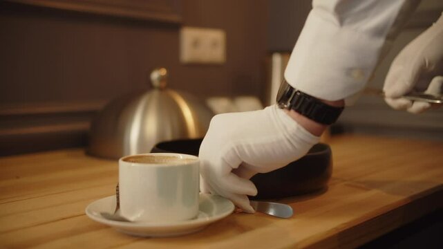 hotel service: waiter serves breakfast in the guest's room