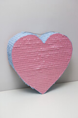 pink blue heart made of cardboard, pi&ntilde;ata heart with candies for a children's party