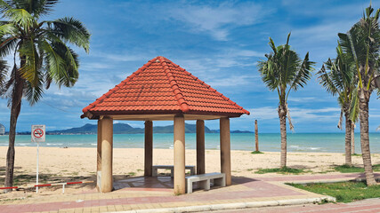 Seaside Pavilion with Red Roof on a Sunny Beach Day