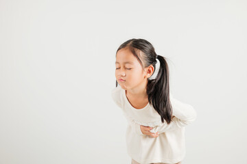 Portrait of Asian young kid girl has stomachache, kindergarten child abdominal pain suffering from...