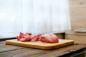 Raw pork shoulder on wooden cutting board