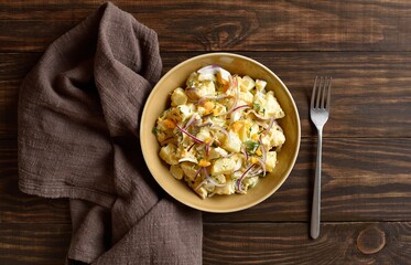 Warm potato salad with egg, pickle, red onion with mayonnaise an