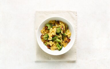 Farfalle pasta with roasted broccoli and mushrooms in bowl