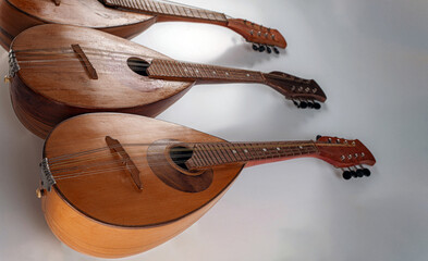 Three old mandolins on a grey background. Selective focus.