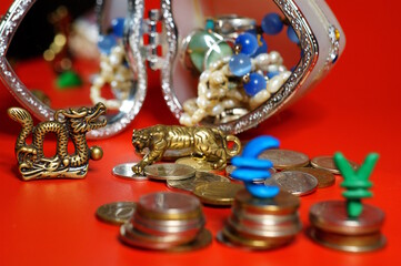A metal figurine of a tiger and a dragon with coins. Finance and economics.