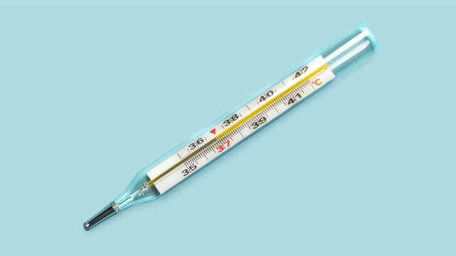 Mercury-in-glass thermometer with temperature mark 38 C isolated on blue background flat lay stopmotion animation slow motion video 4k