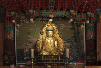 Jinjeop-eup, Namyangju-si, Gyeonggi-do, South Korea - June 25, 2023: Interior and front view of a golden Buddha statue in Gwaneumjeon Hall of Bongseonsa Temple
