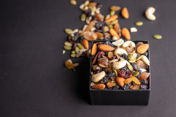 healthy and organic dry fruits kept on a dark grey background
