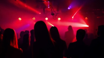 Silhouette, party or crowd in a underground club, dance concert dancing with freedom in crazy rock music festival at night. Audience, nightclub and excited people at a techno, rave or punk disco event