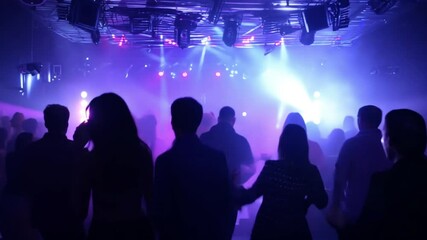 Silhouette, party or crowd in a underground club, dance concert dancing with freedom in crazy rock music festival at night. Audience, nightclub and excited people at a techno, rave or punk disco event