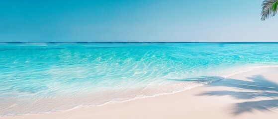 Peaceful tropical beach with crystal clear turquoise water, white sandy shore, and palm tree shadow casting over the pristine scene.