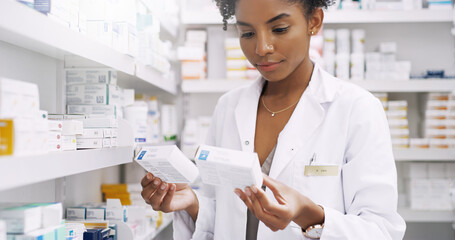 Woman, pharmacist and reading with box of medication for side effects or symptoms at pharmacy. Young African, female person or medical employee checking expiry date on pharmaceutical product