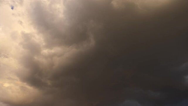 The weather changes from stormy clouds to clear blue evening skies. A little bit of rainbow. Time lapse.