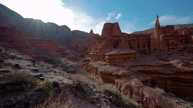 Picturesque red rock canyon in Kyrgyzstan on summer day, panoramic view