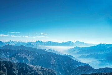 Fototapeta premium Majestic mountain vista with a clear blue sky, showcasing nature's grandeur.