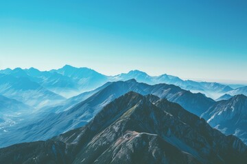 Majestic mountain vista with a clear blue sky, showcasing nature's grandeur.