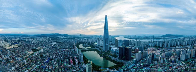 Jam-sil, Songpa-gu, Seoul, South Korea - August 20, 2023: Panoramic and afternoon view of villas and apartments with Lotte World Tower and Seokchon Lake against Han River 