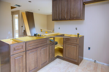 Assembly of new custom kitchen cabinets during construction home improvement project