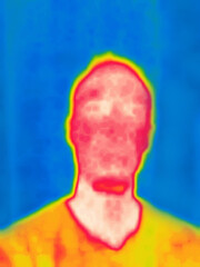A young man with a beard and a T-shirt.Image from thermal imager device.