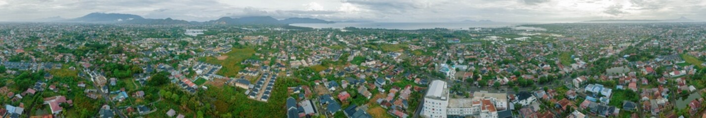 Panoramic aerial drone view of big city skyline scenery in Banda Aceh, Aceh, Indonesia.