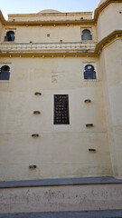 A picture of a building in Udaipur palace which shows the beautiful architecture high is unique to Rajasthan
