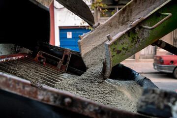 Pouring concrete from a mixer truck.
