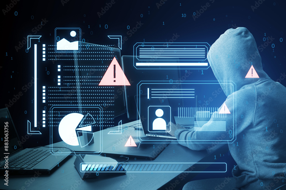 Aufkleber A hooded figure using a laptop with cyber security graphics overlay, symbolizing a cyber attack on a dark blue background
