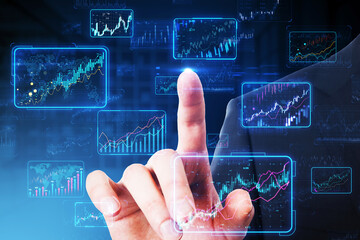 A hand interacting with futuristic stock market graphs on a digital interface, concept of financial technology