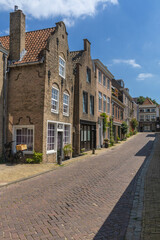 Gorinchem, the Netherlands. 25 June 2024. Typical historic brick houses and street in the fortified city Gorinchem along the bridge and canal Linge.