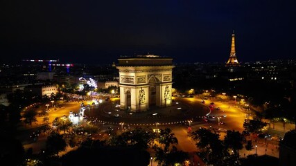 Paris, Arc de Triomphe Triumphal Arch at Chaps Elysees at night, Paris, France. Drone view, Eiffel Tower in the background.  Architecture and landmarks of Paris. Postcard of Paris
