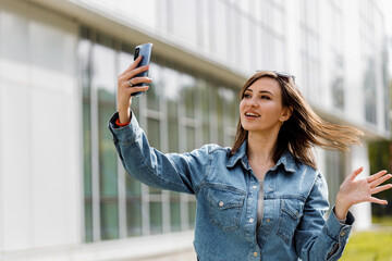 Young Woman Taking Selfie With Smartphone in Urban Setting