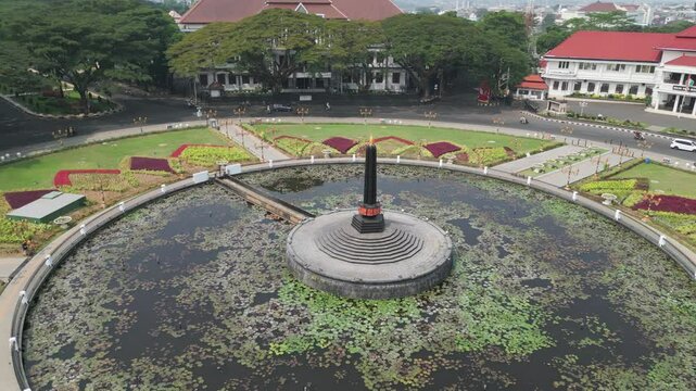 View of Tugu Malang square in front of Malang city hall in the middle of gardens and ponds with lots of plants and lotus flowers in Malang city, East Java, Indonesia