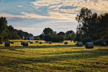 Heuballen - bales of hay - field - harvest - summer - straw - farmland - blue cloudy sky - golden - beautiful - freshly - countryside - haystacks - harvesting - background 