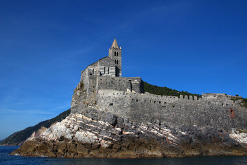 From the sea, view of the Church of San Pietro de Porto Venere on its rocky outcrop (Cinque Terre, Liguria, Italy)