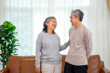 asian senior couple standing and conversation in the living room,concept of elderly lifestyle,domestic life,family,relationship