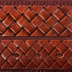 Seamless 4k photo texture photo of brown colored braided leather material belts with on stitched leather surface.