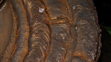 A piece of metal with a lot of rust and dirt on it