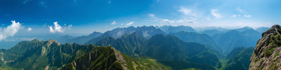Fototapeta premium Wide panoramic photo of the mountains against the blue sky