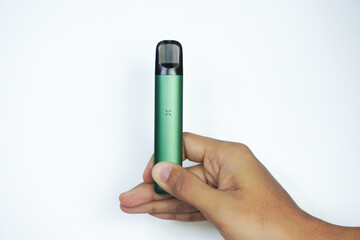disposable electronic cigarette in a man's hand on white background. The concept of modern...