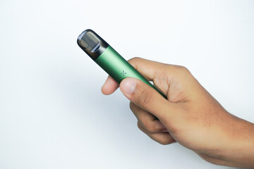 disposable electronic cigarette in a man's hand on white background. The concept of modern alternative smoking, vaping and nicotine