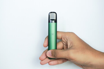 disposable electronic cigarette in a man's hand on white background. The concept of modern alternative smoking, vaping and nicotine