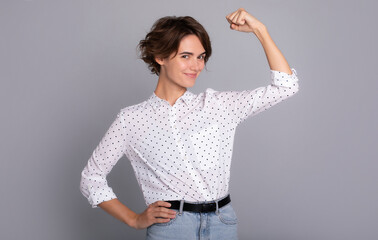 Smiling excited confident beautiful business woman in smart casual wear showing her strong biceps...