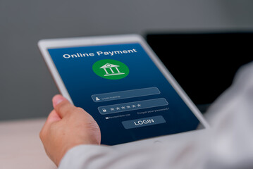 Hand holding a tablet displaying an online payment login screen. digital banking and secure financial transactions. finance online banking guides, and digital payment security articles.