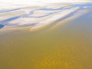Low water level in Vistula river, effect of drought seen from the bird's eye view. Top down perspective landscape.