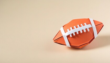 sports and competition paper origami concept of an American college high school junior striped or NFL football pigskin isolated on white background with copy space