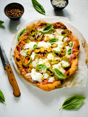 Delicious small pizza with mushrooms, peppers and basil