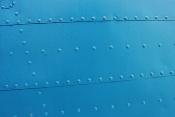 Fototapeta premium Photo of a metal surface with rivets.