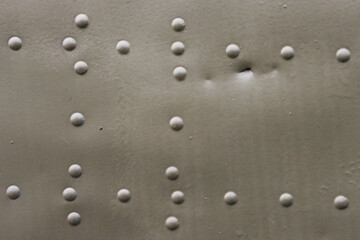 Old, damaged aircraft skin close-up.